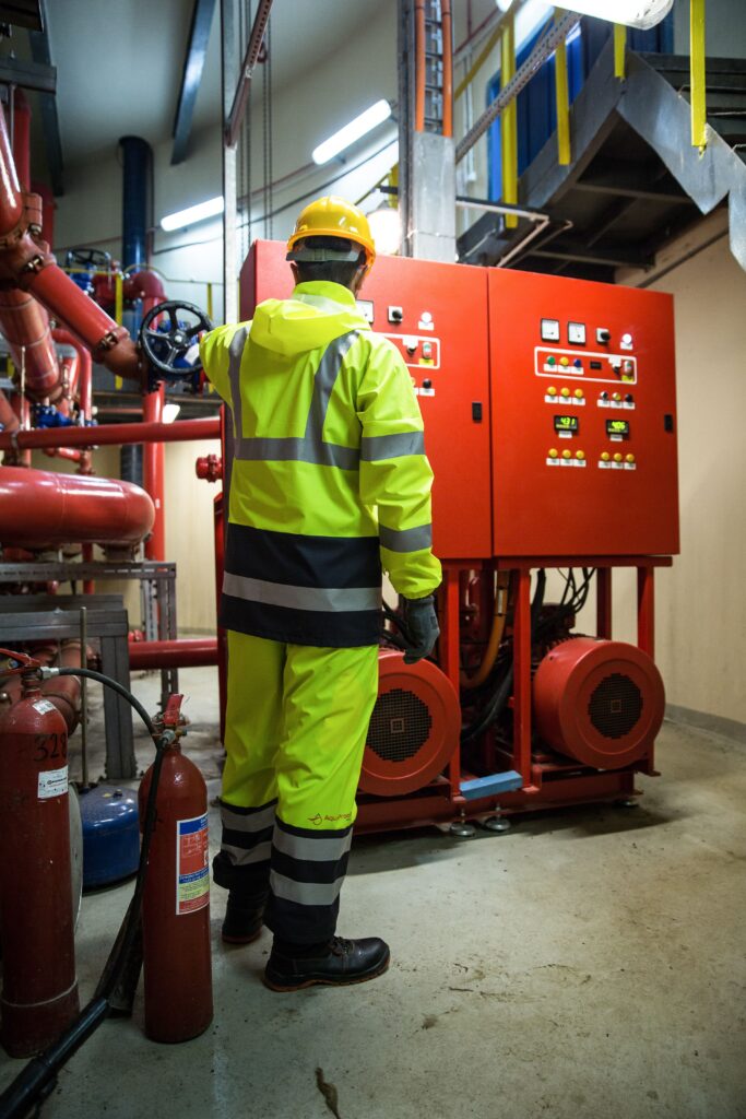 Technician inspecting a fire suppression system control panel