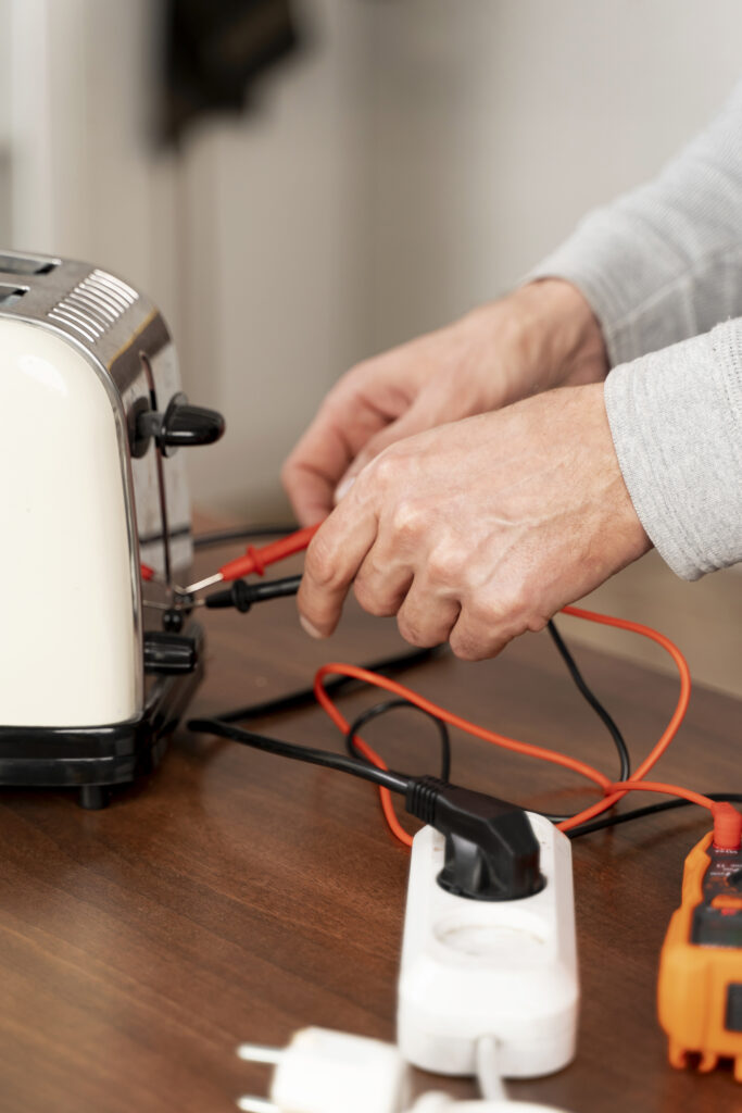 PAT testing a toaster with a multimeter